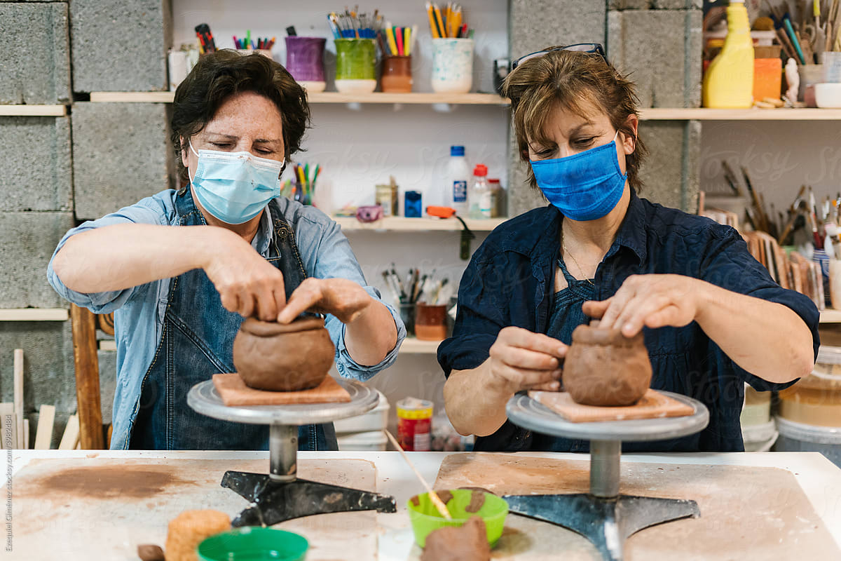 Adult women potters with masks