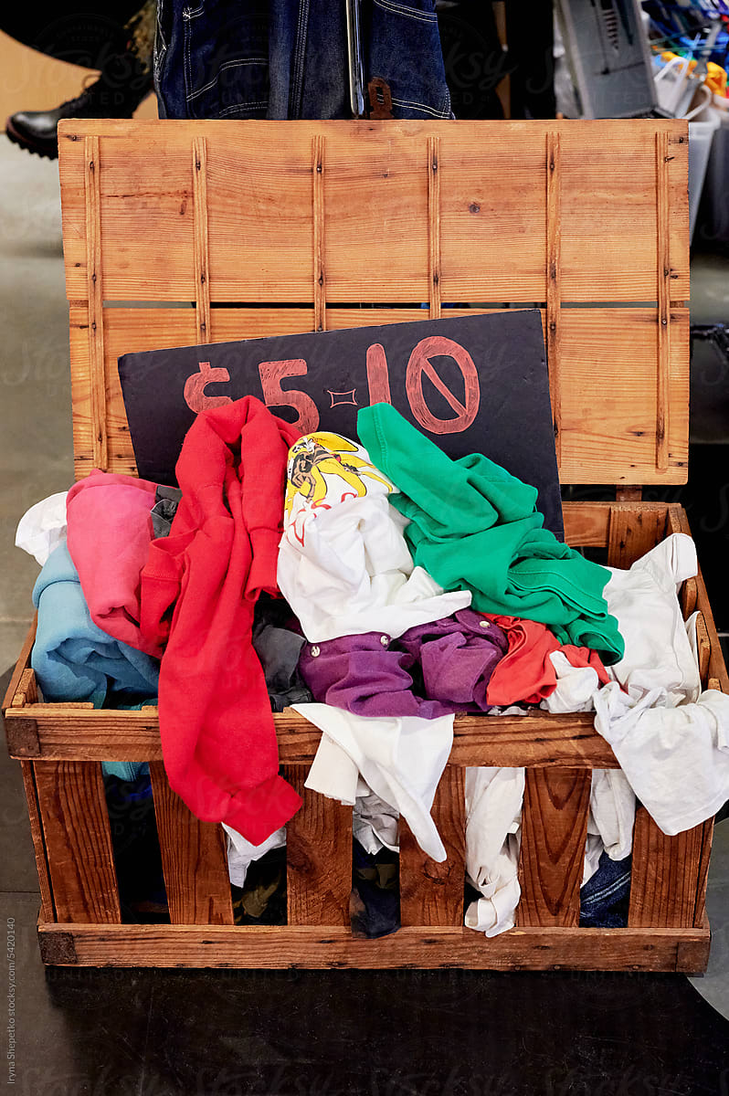Box with t-shirts at the vintage market, second-hand clothing