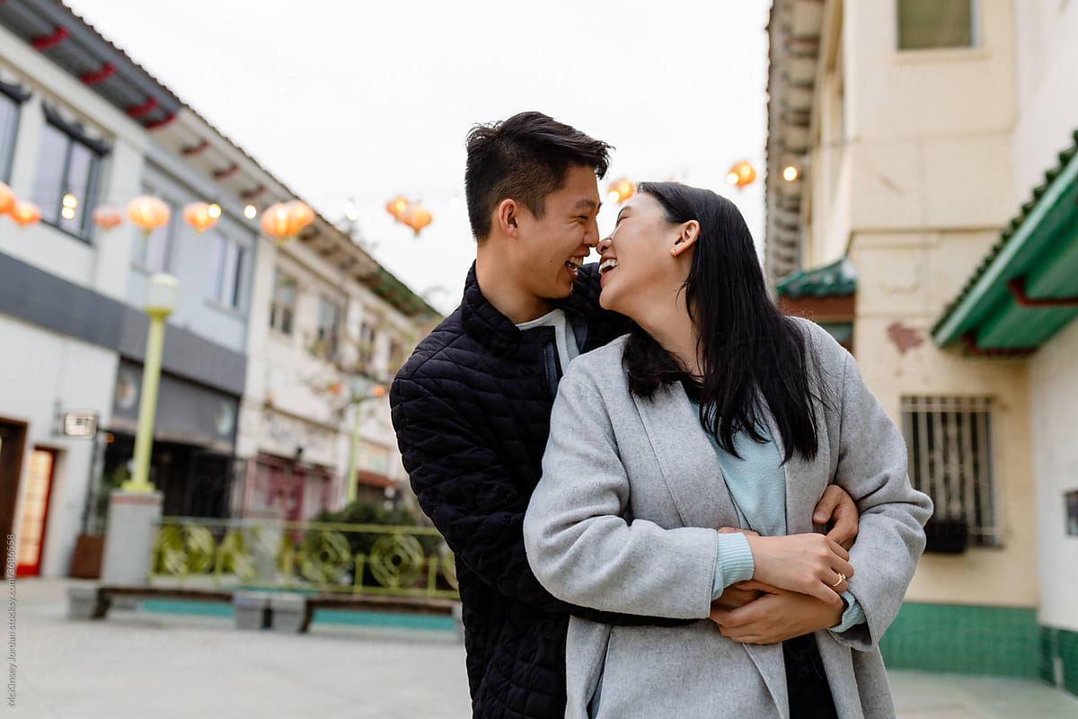 Romantic Asian Couple Embrace While on a Date in Chinatown