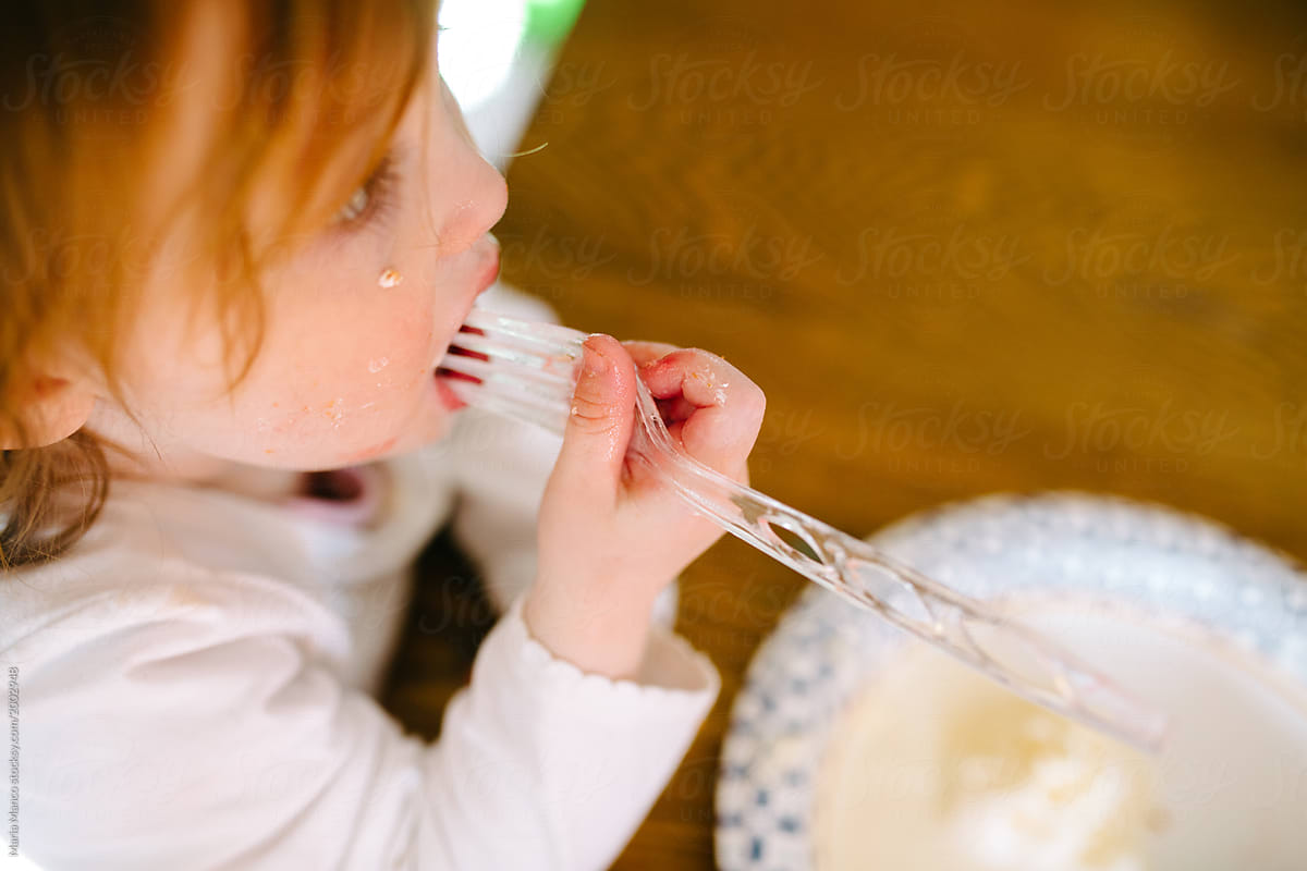 toddler eating cake and making a mess