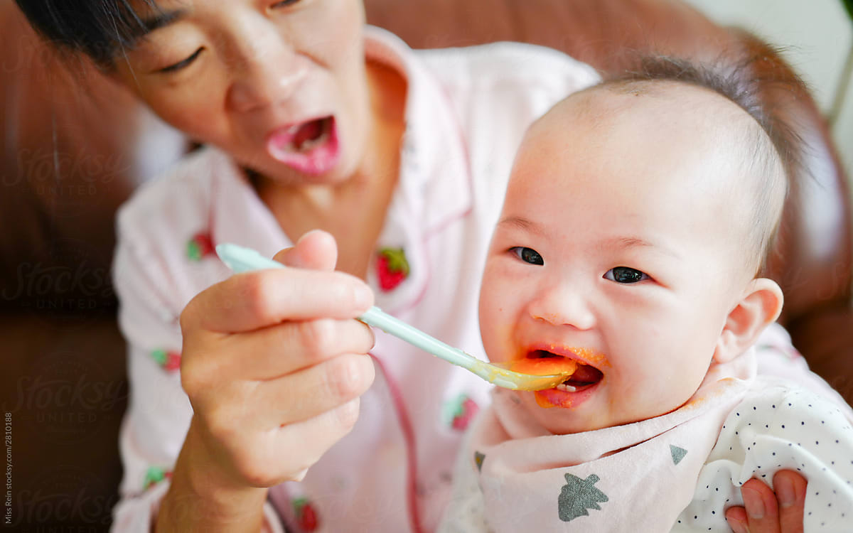 Asian baby eating complementary food