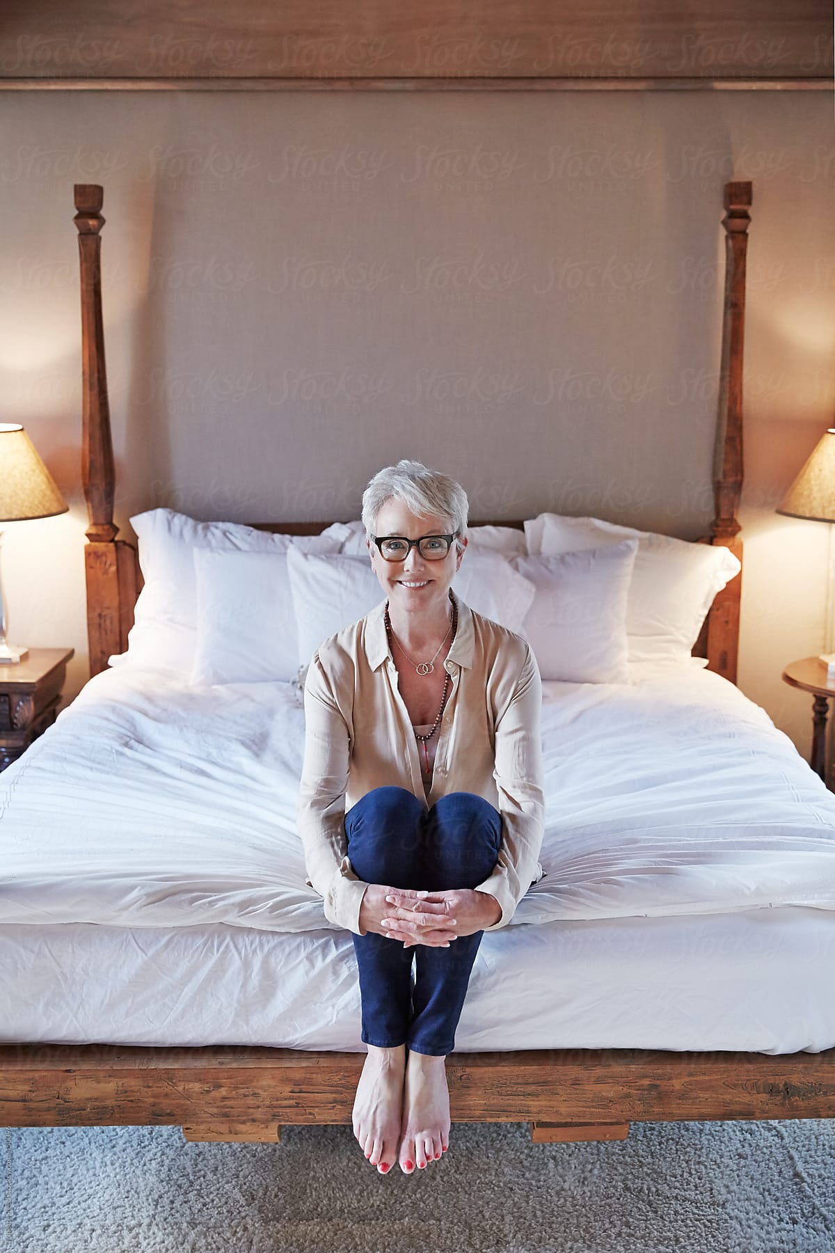 Portrait Of Mature Woman With Grey Hair Relaxing In Bedroom By Stocksy Contributor Trinette