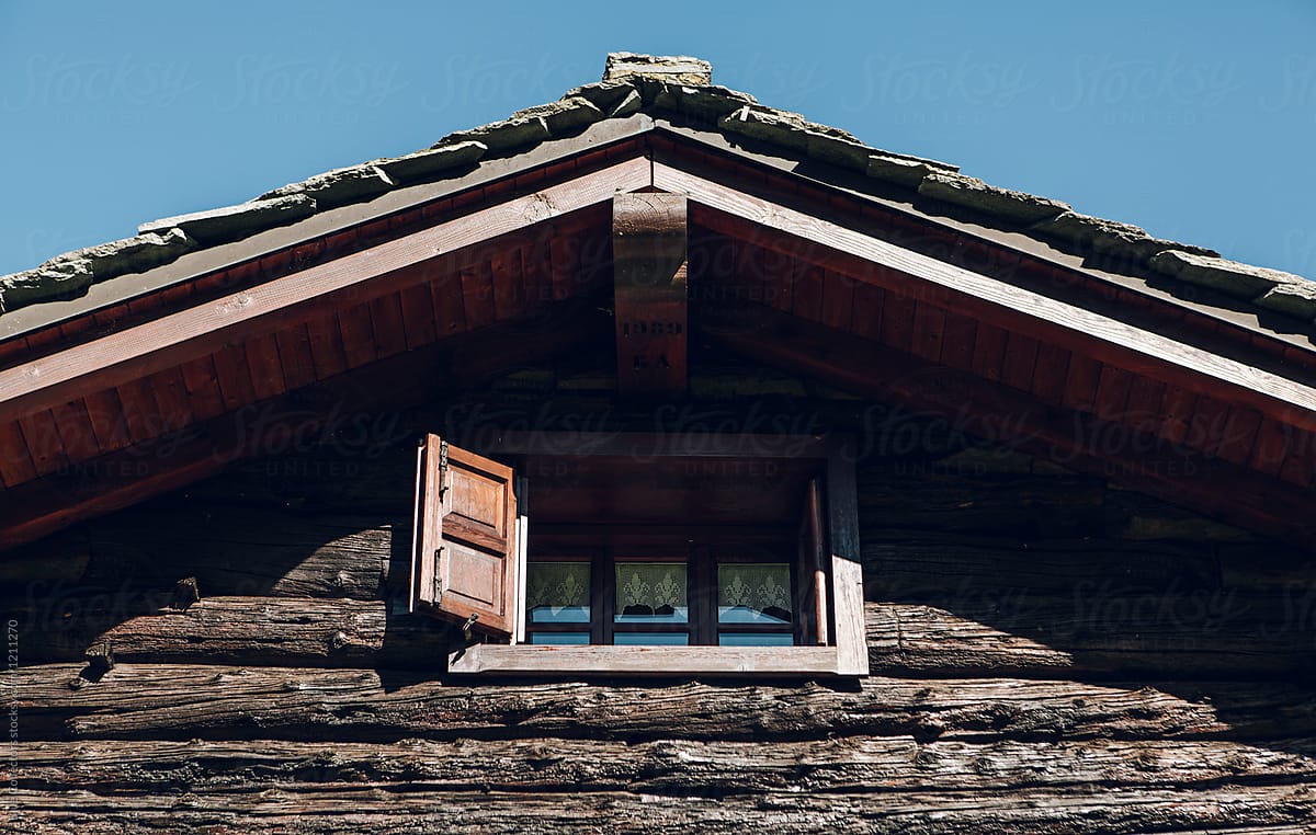 Vintage wooden dormer window in the mountain and foggy weather