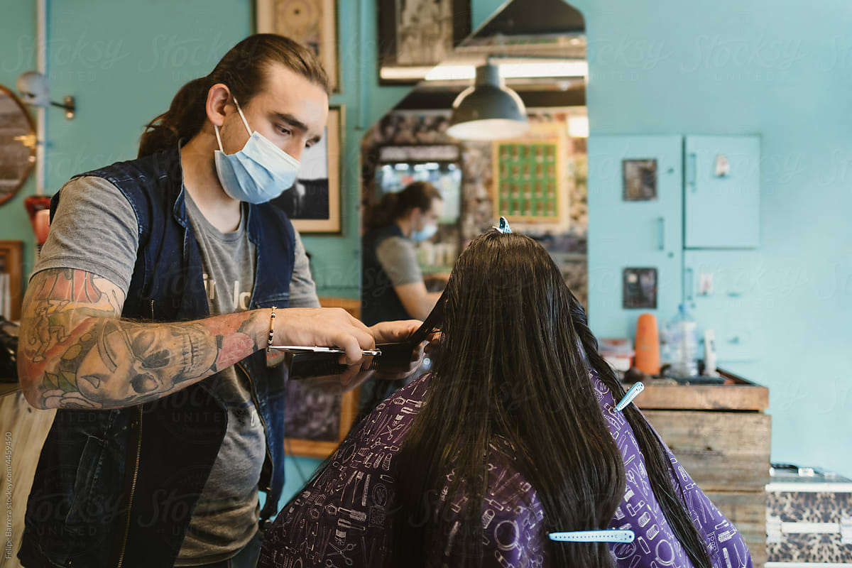 Hairdresser combing a customer