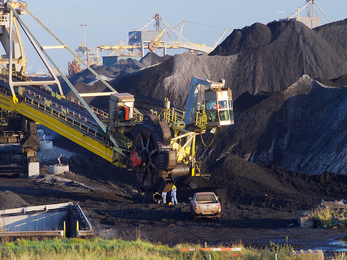 Repairing coal mine machinery, piles of coal suggest Anthropocene carbon footprint