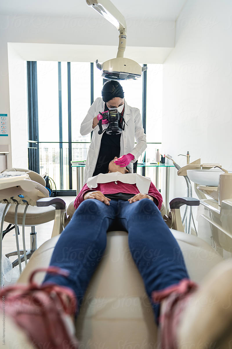 Dentist Photographing Her Patient