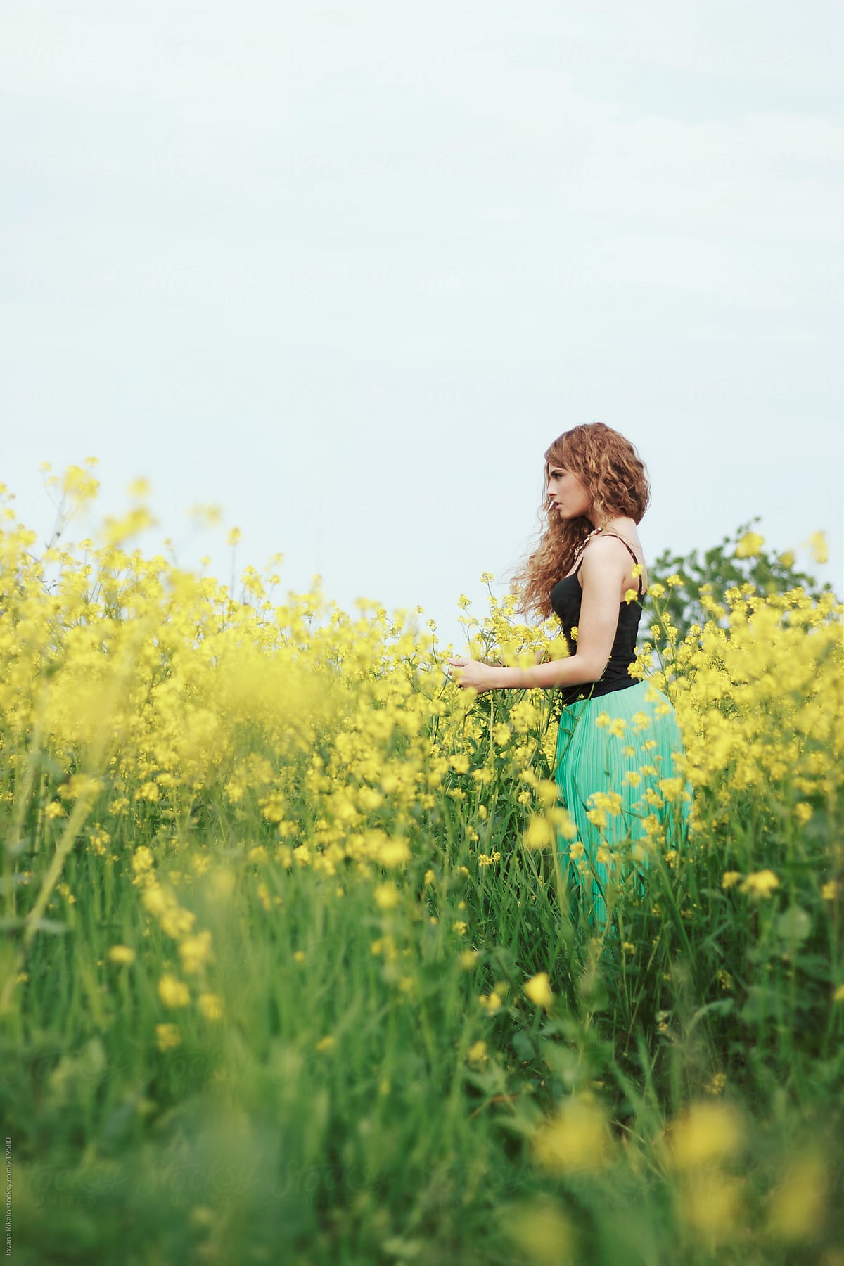 Young Beautiful Woman Standing In A Field Full Of Flowers By Stocksy Contributor Jovana