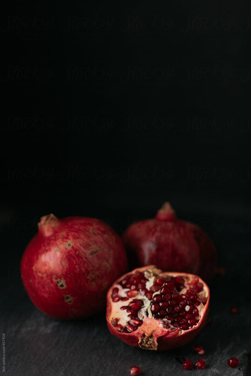 Fresh Pomegranate on slate in a dark moody kitchen