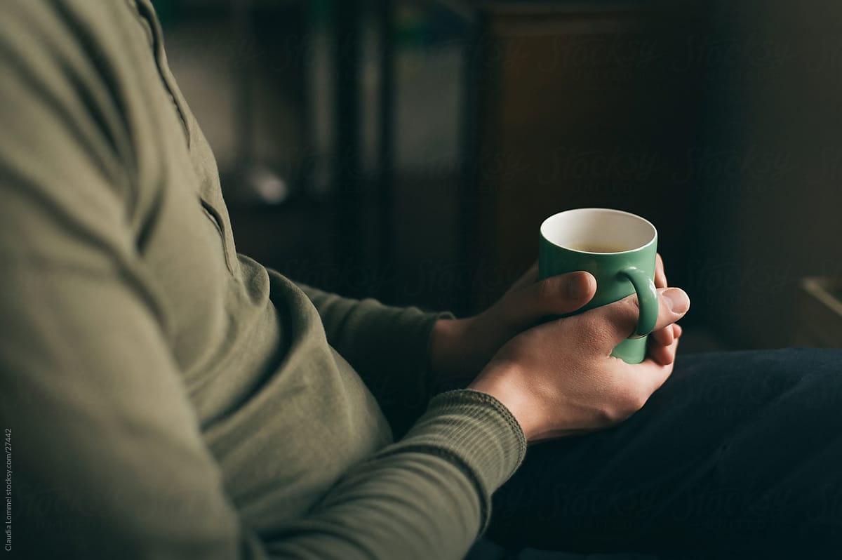 Relaxed Man Holding a Green  Mug