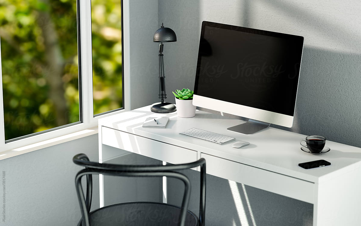 Minimalist workspace with computer on white table