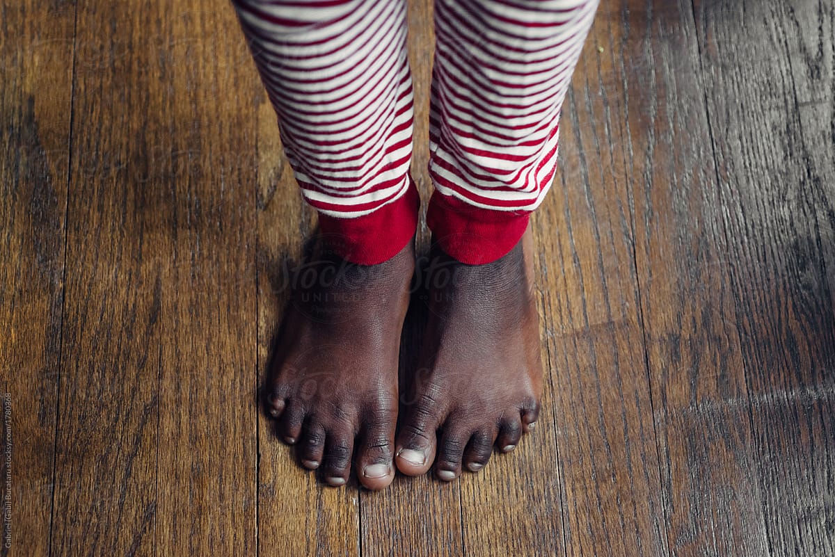 Black girl\'s feet wearing Christmas pajamas