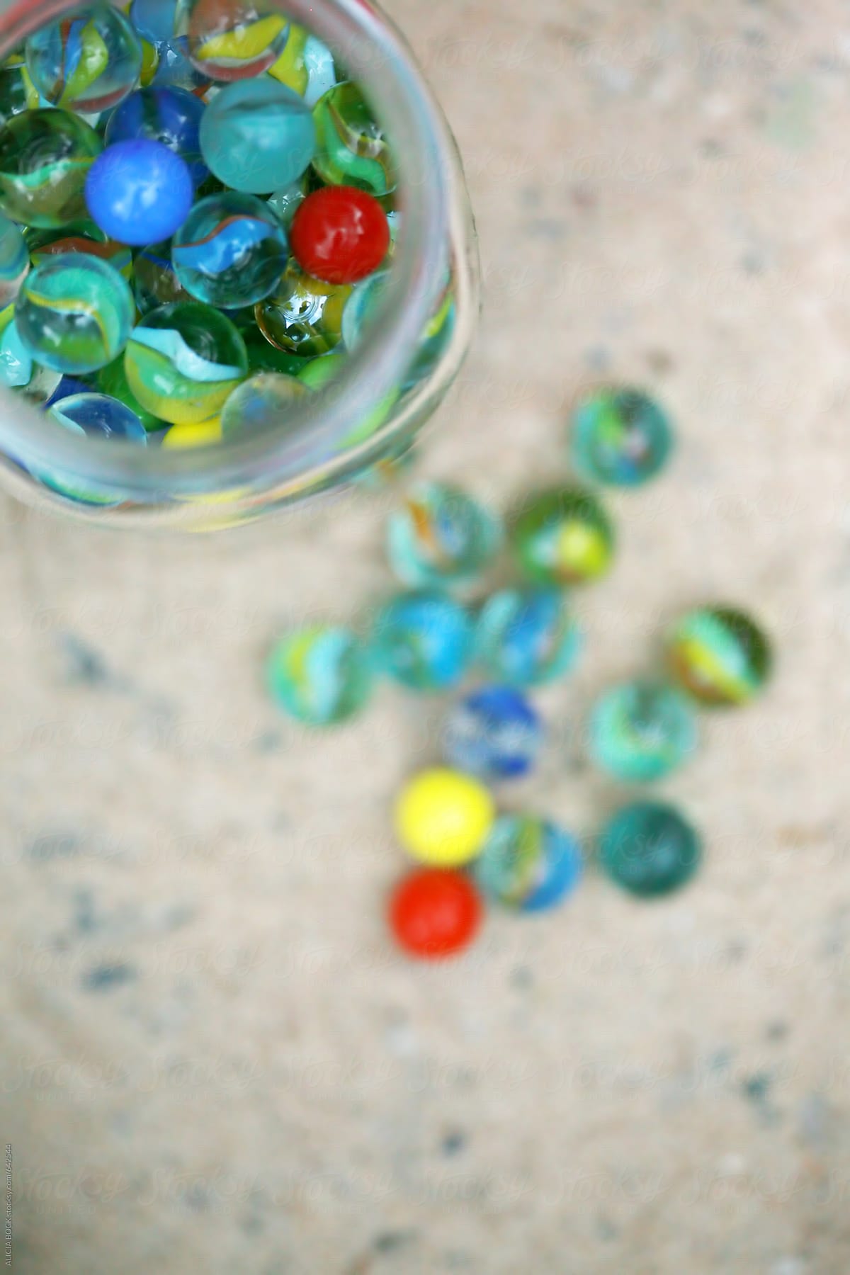 A Jar Of Colorful Glass Marbles Ready To Start A Game In The Sand