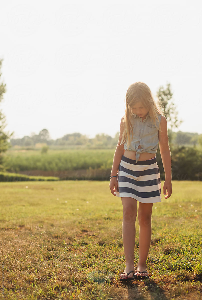Cute Blonde Girl In A Striped Skirt Del Colaborador De Stocksy