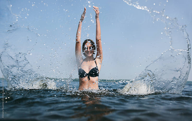 happy young woman playing with water