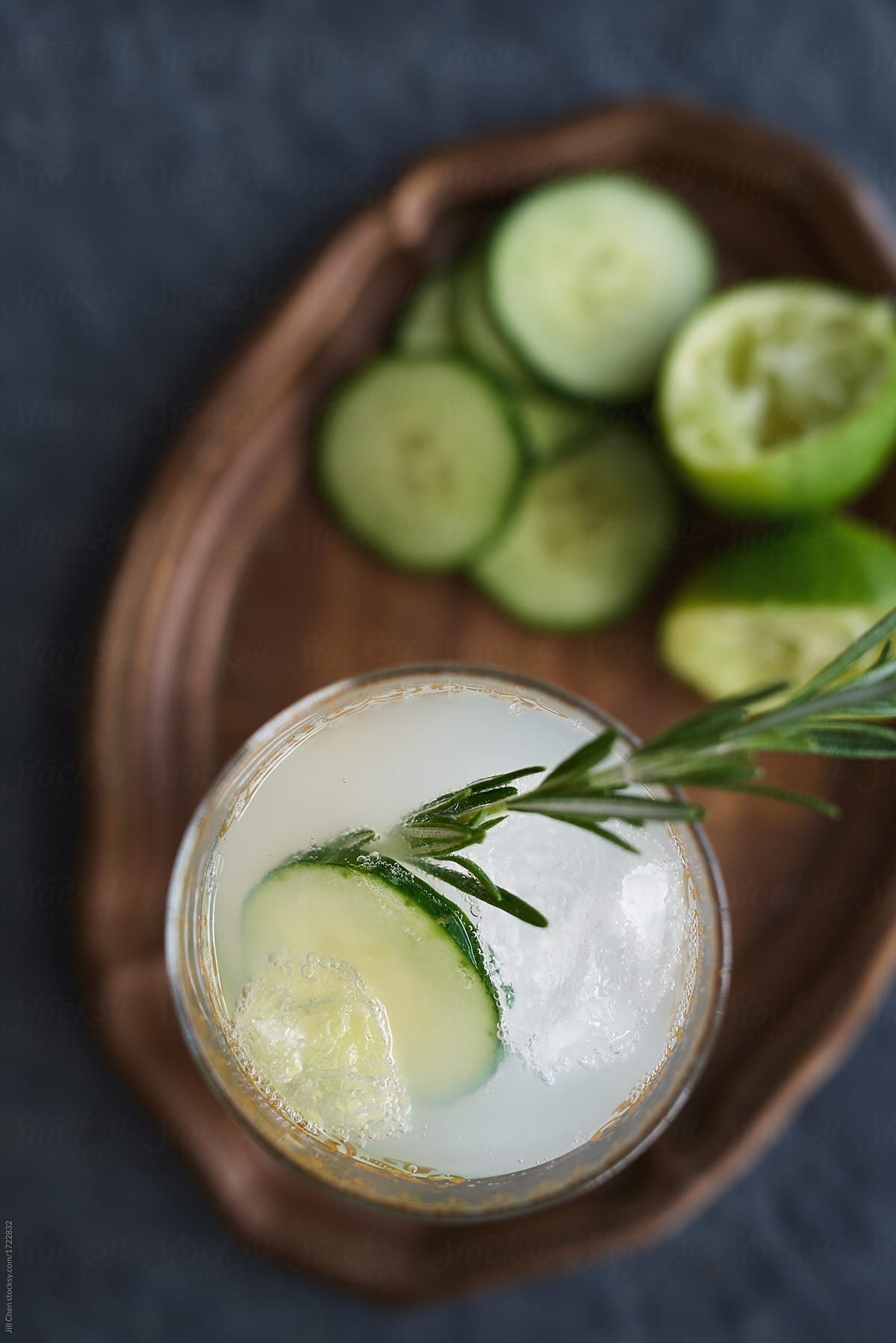 Overhead of lime cocktail with cucumber and rosemary