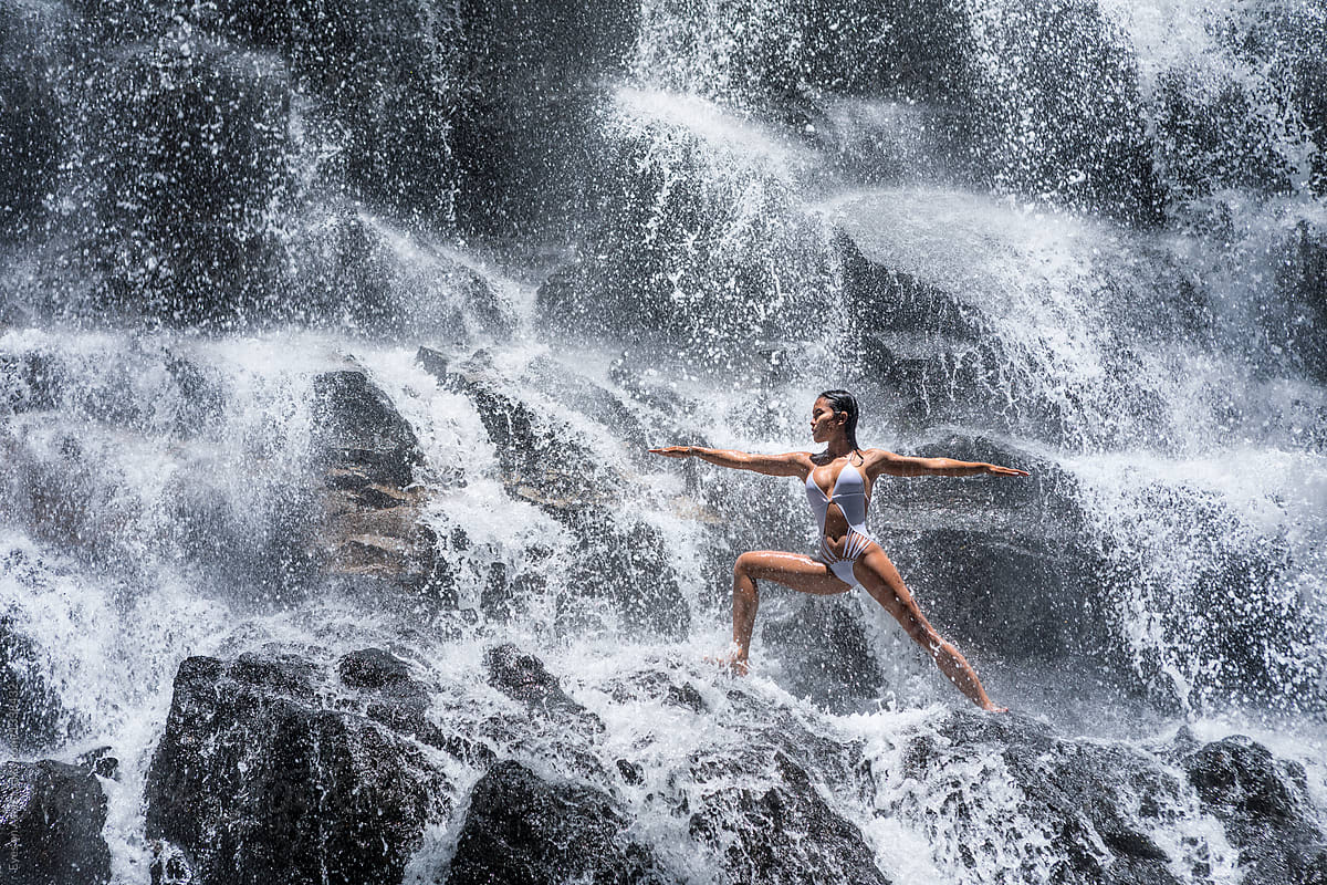 Young Woman In A Yoga Pose At The Waterfall Stock Photo, Picture and  Royalty Free Image. Image 44582029.