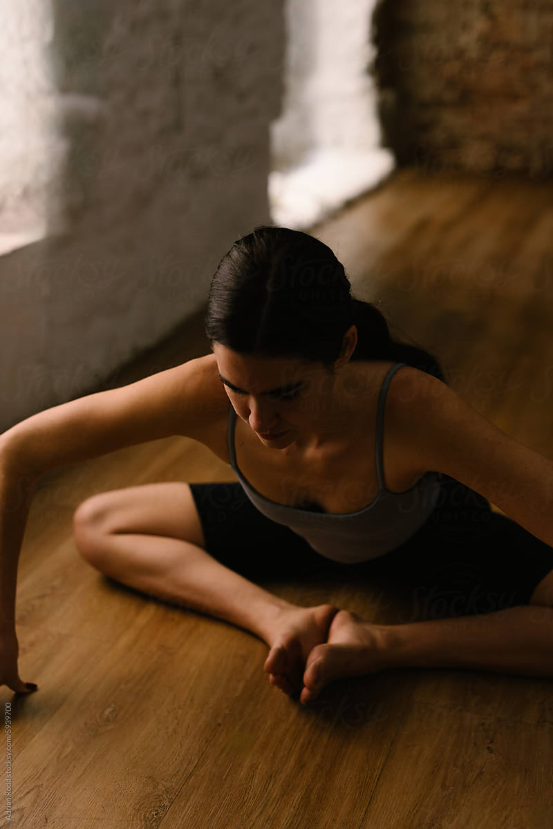 Woman who practices yoga professionally trains her body's flexibility