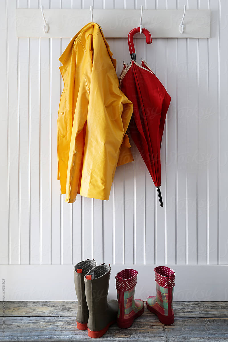 Rain gear with boots hanging on coat hooks