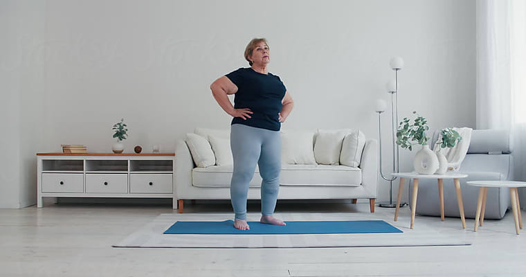 Plus Size Woman Doing Cat Pose On Mat by Stocksy Contributor