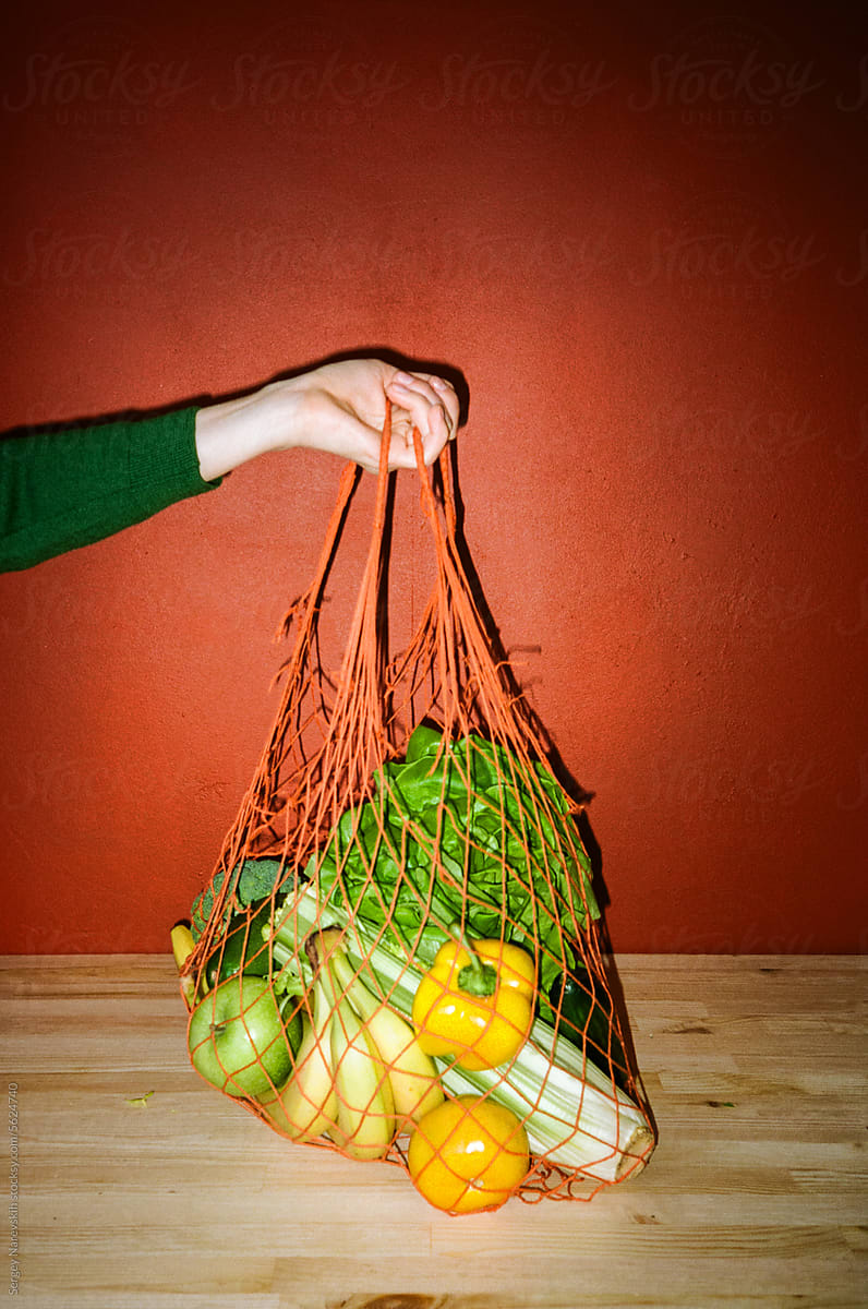 Person with reusable bag with various vegetable products, film