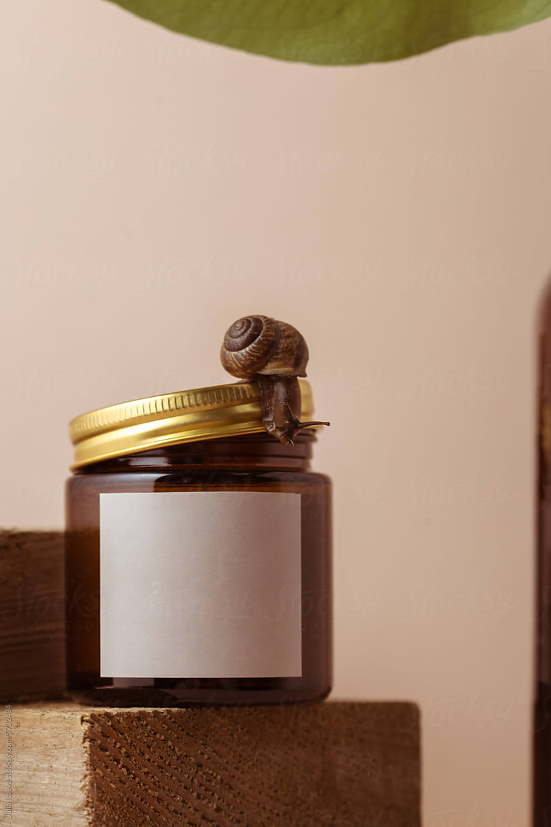 a mock-up of a jar with candles and a snail