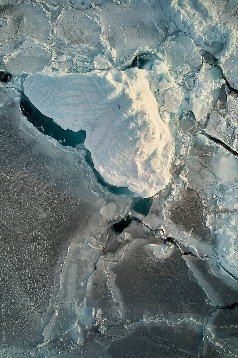 Aerial, Greenland Arctic iceberg, winter - large berg in polar sea ice