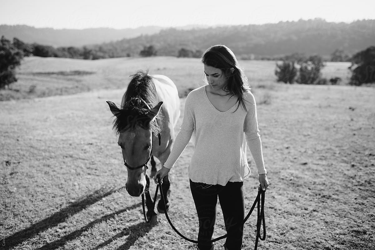 Girl guiding horse