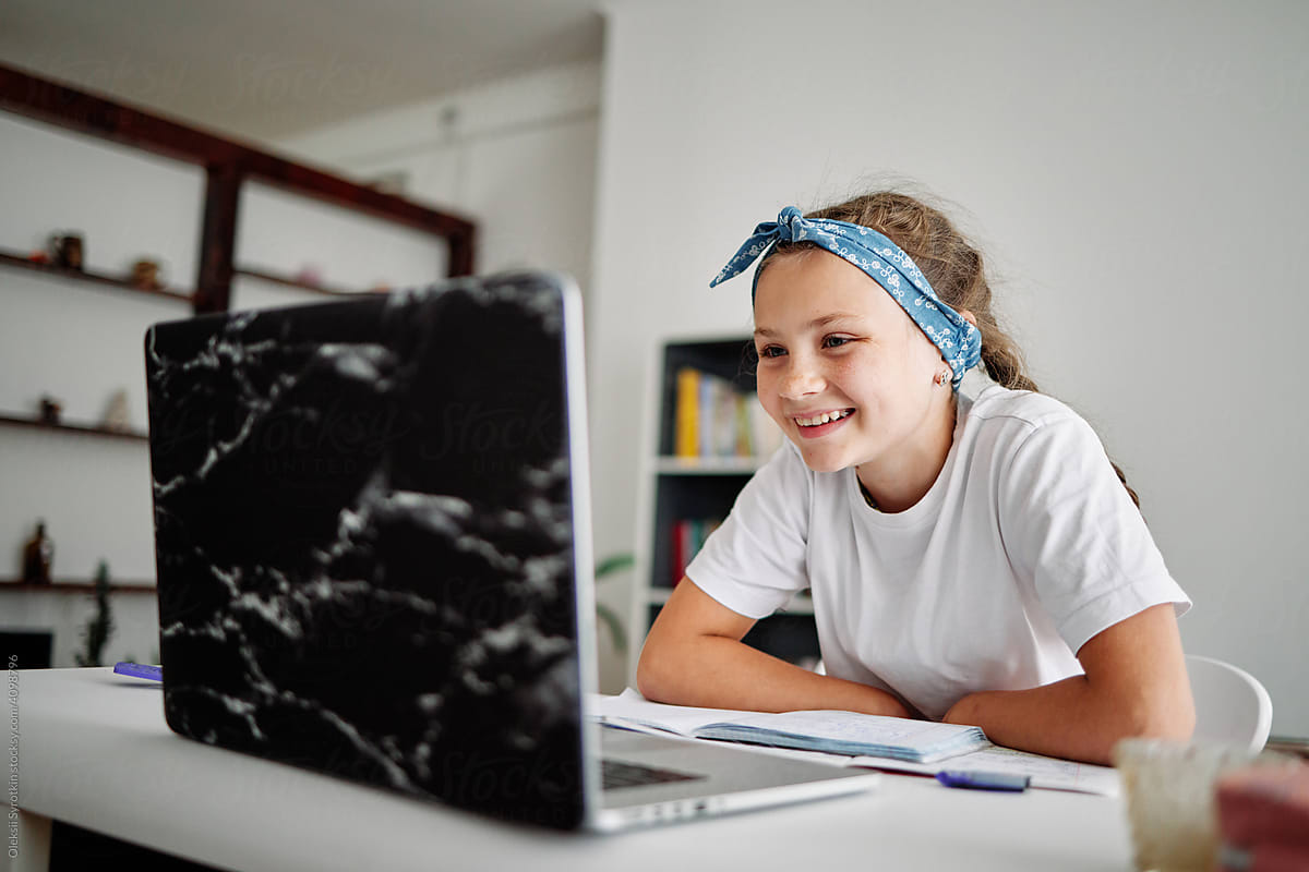 Girl looking at screen and enjoying education at home