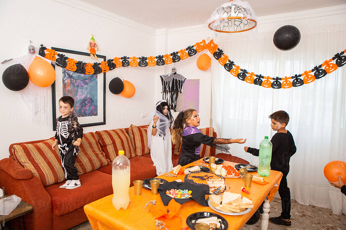 Children play with balloons at halloween party.