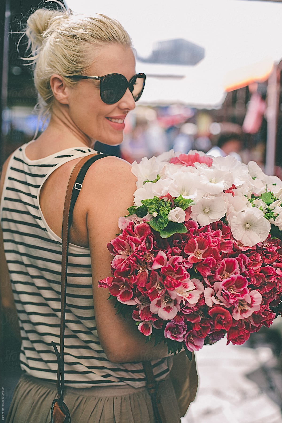 Smiling Woman Carrying Flowers