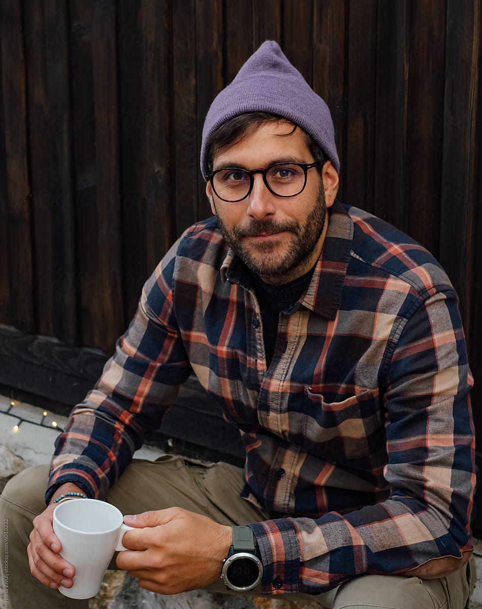 Handsome Man With Glasses Sitting With Coffee Cup.