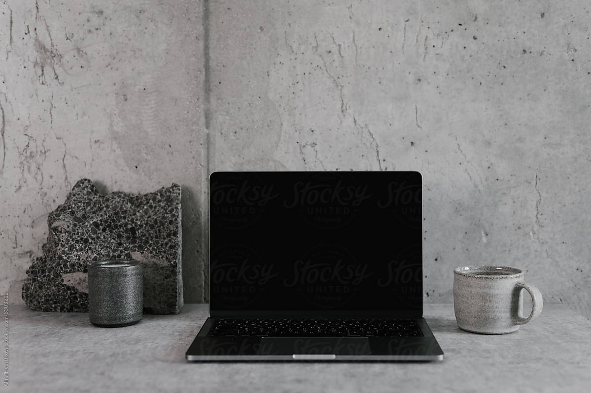 Table with laptop and cup of coffee in minimalist workplace