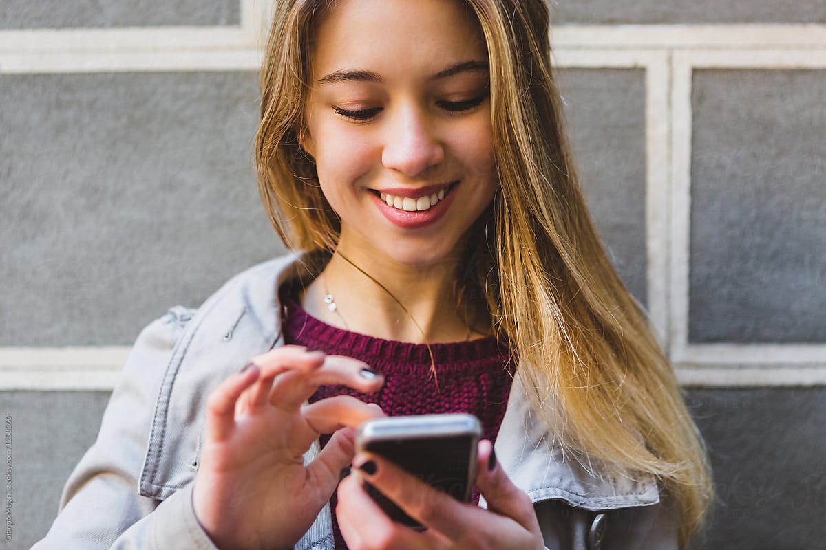 Teenage Girl Texting On A Mobile Phone By Stocksy Contributor Giorgio Magini Stocksy
