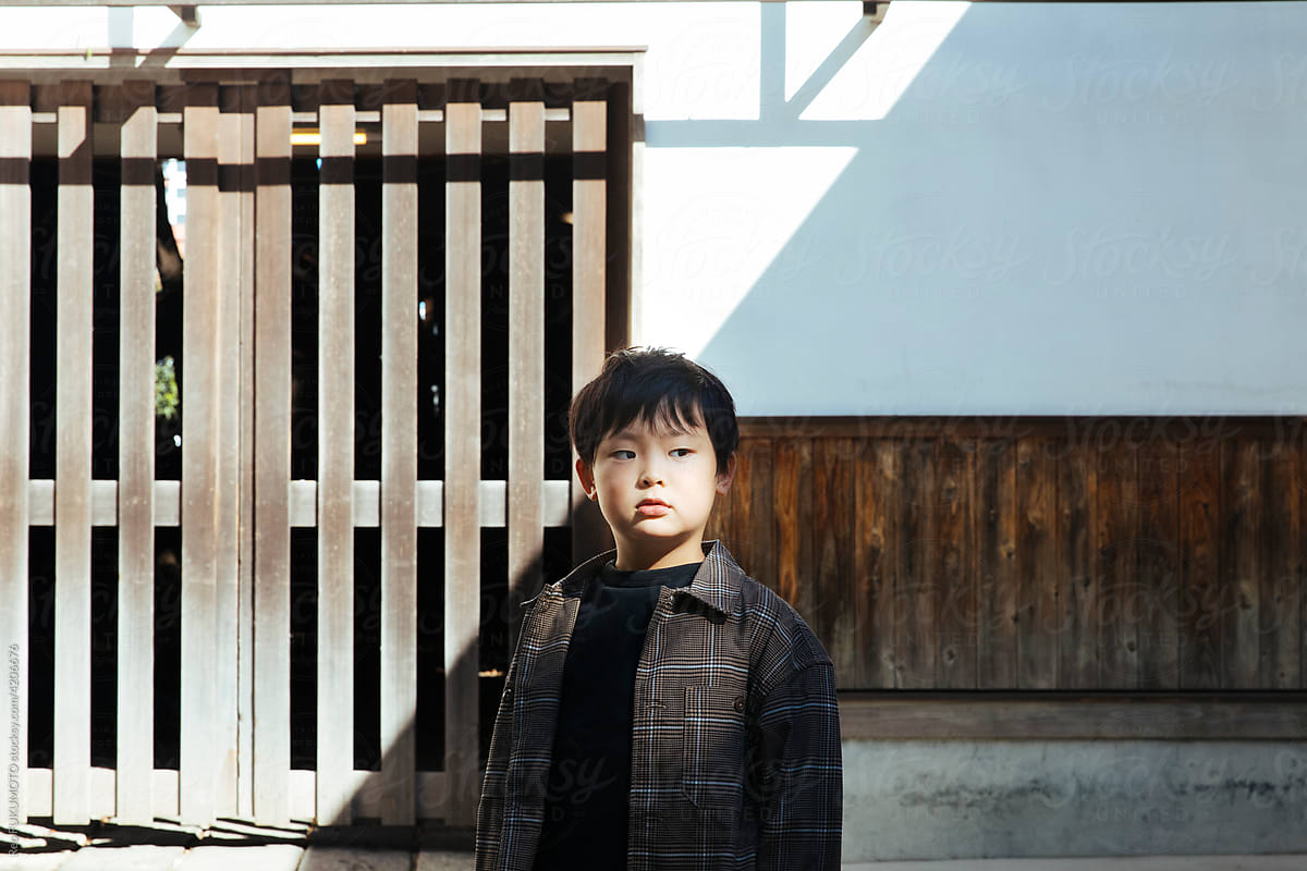 A boy standing at the shrine