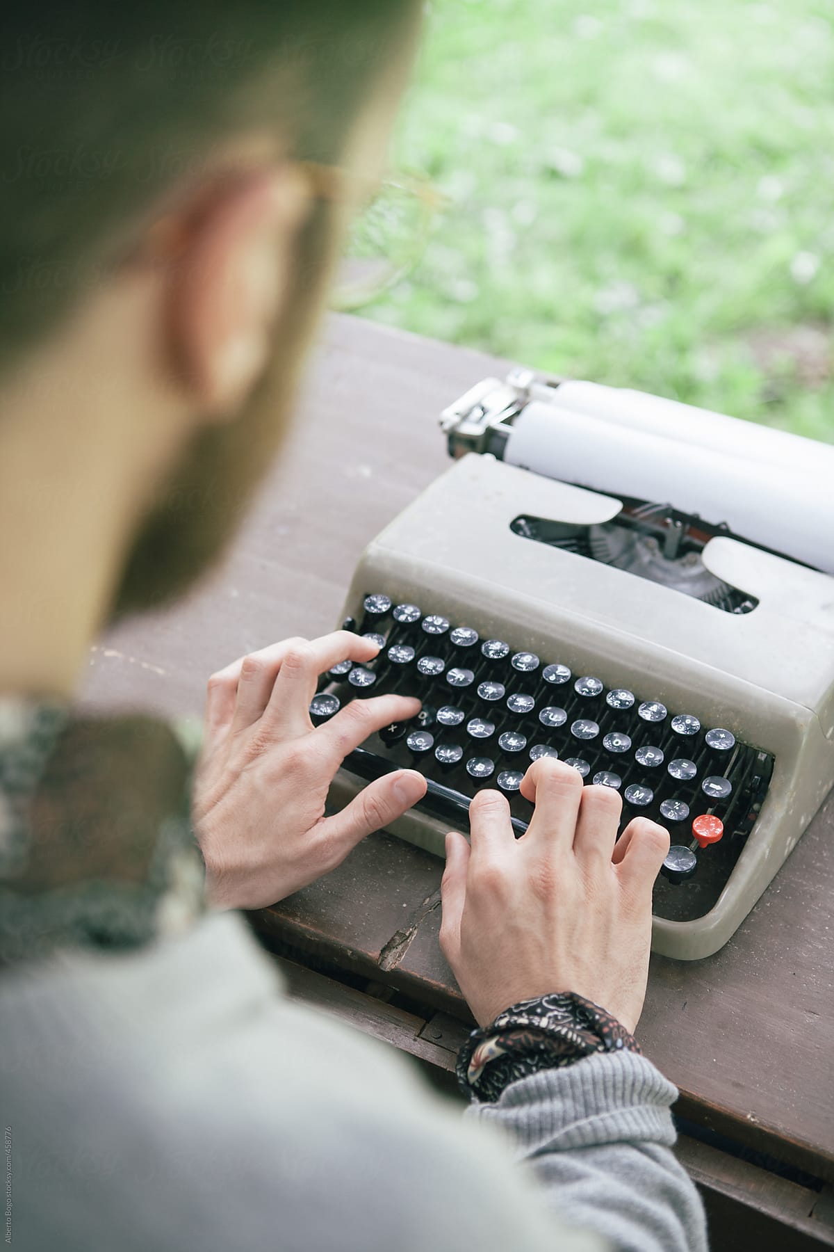 Man working on a typewriter in the garden