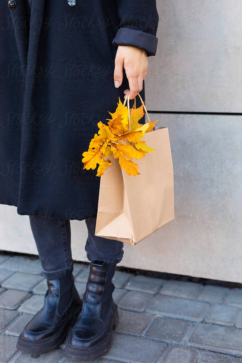 woman's hand holding a bag of leaves