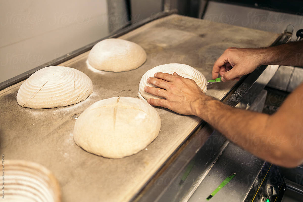 Baker working with bread dough to bake it
