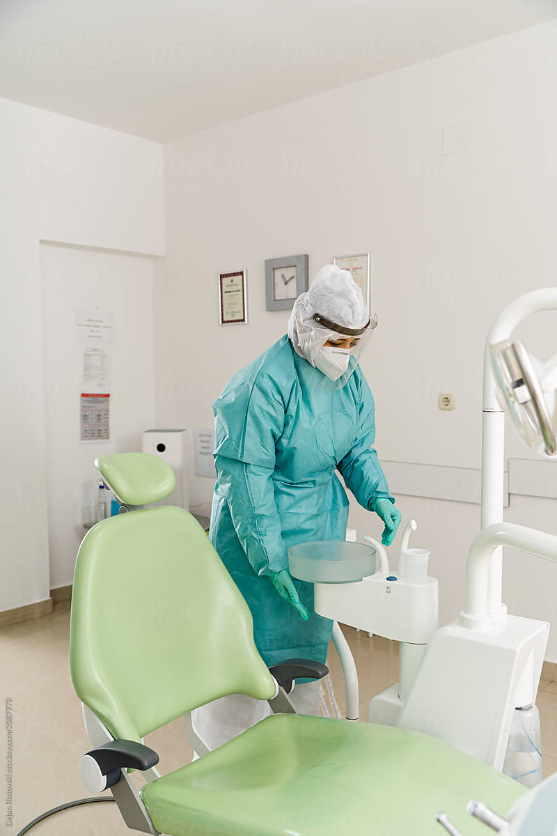 Assistant cleaning after patient in dental clinic