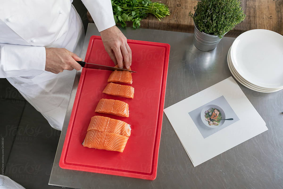 Chef cutting salmon during a kitchen class