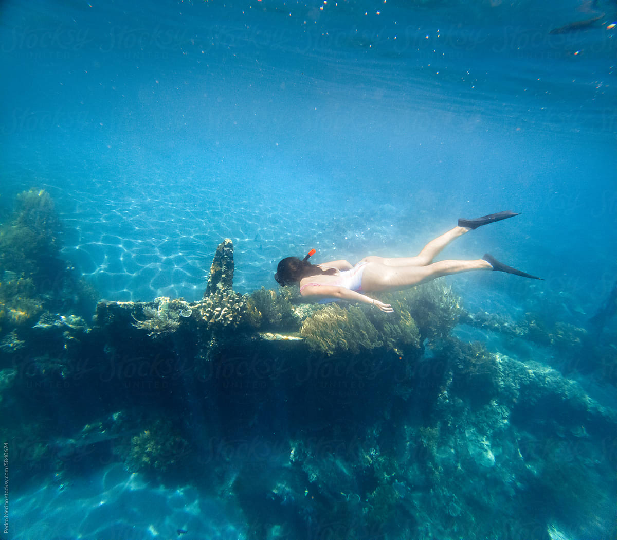 Woman free diving in Bali