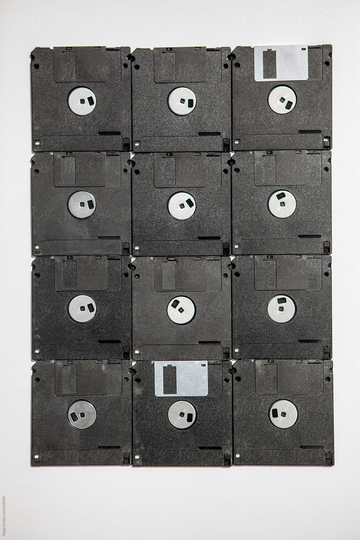 Twelve floppy disks laid out in a rectangle