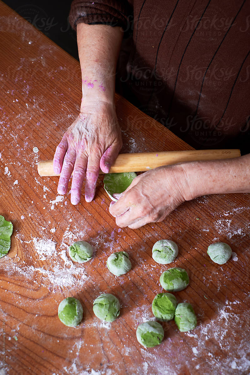 Close-up, old man's kneading dough, making dumplings