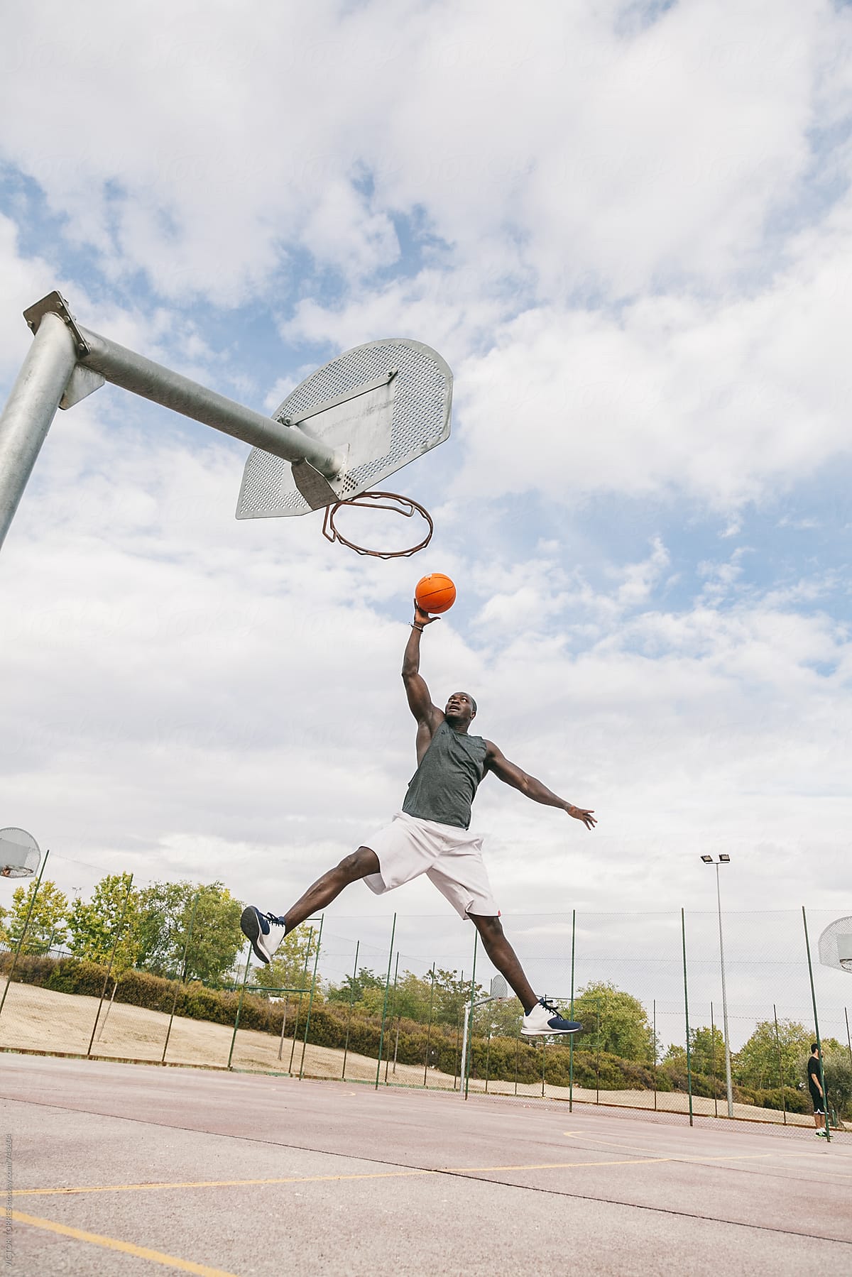Young Black Man Playing in a Street Basketball Court