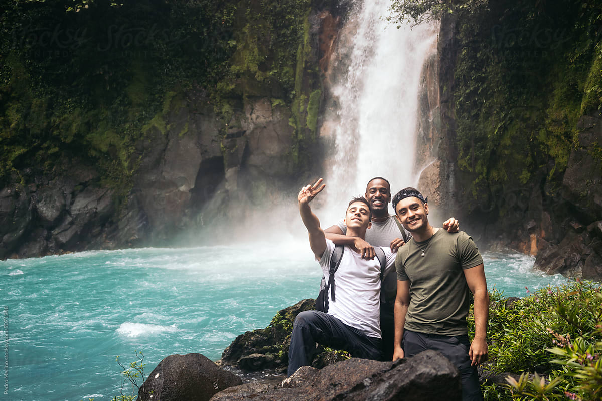 Friends visiting the Rio Celeste waterfall in Costa Rica