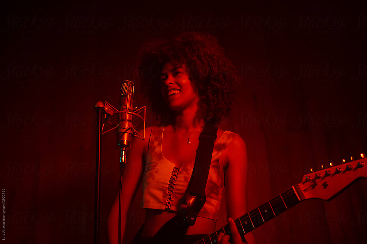 Black Girl Playing The Guitar In The Studio.