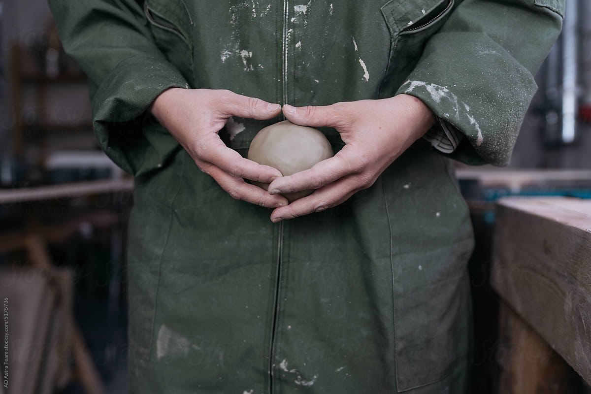 Ceramist\'s hands holding a clay ball