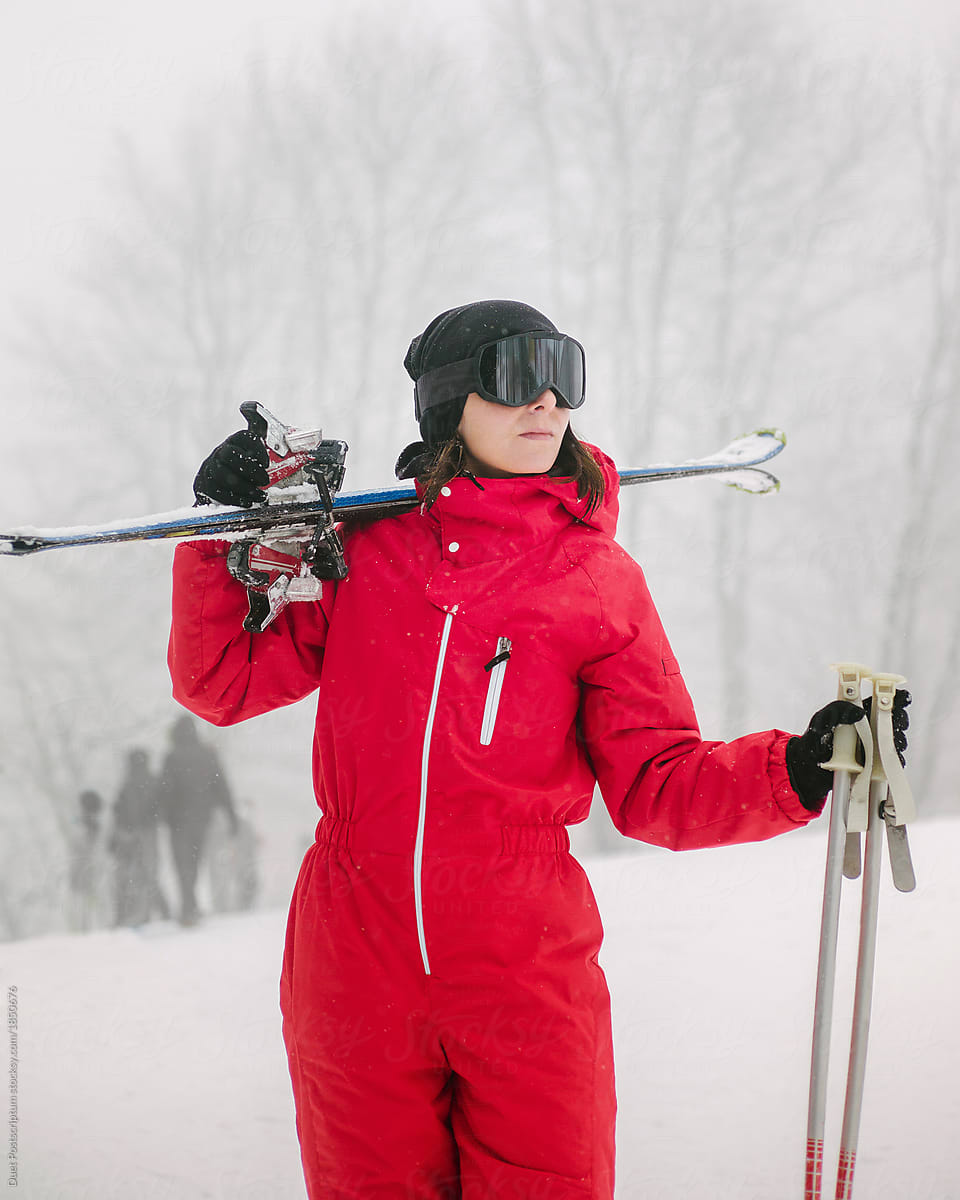 Woman in glasses with ski and sticks