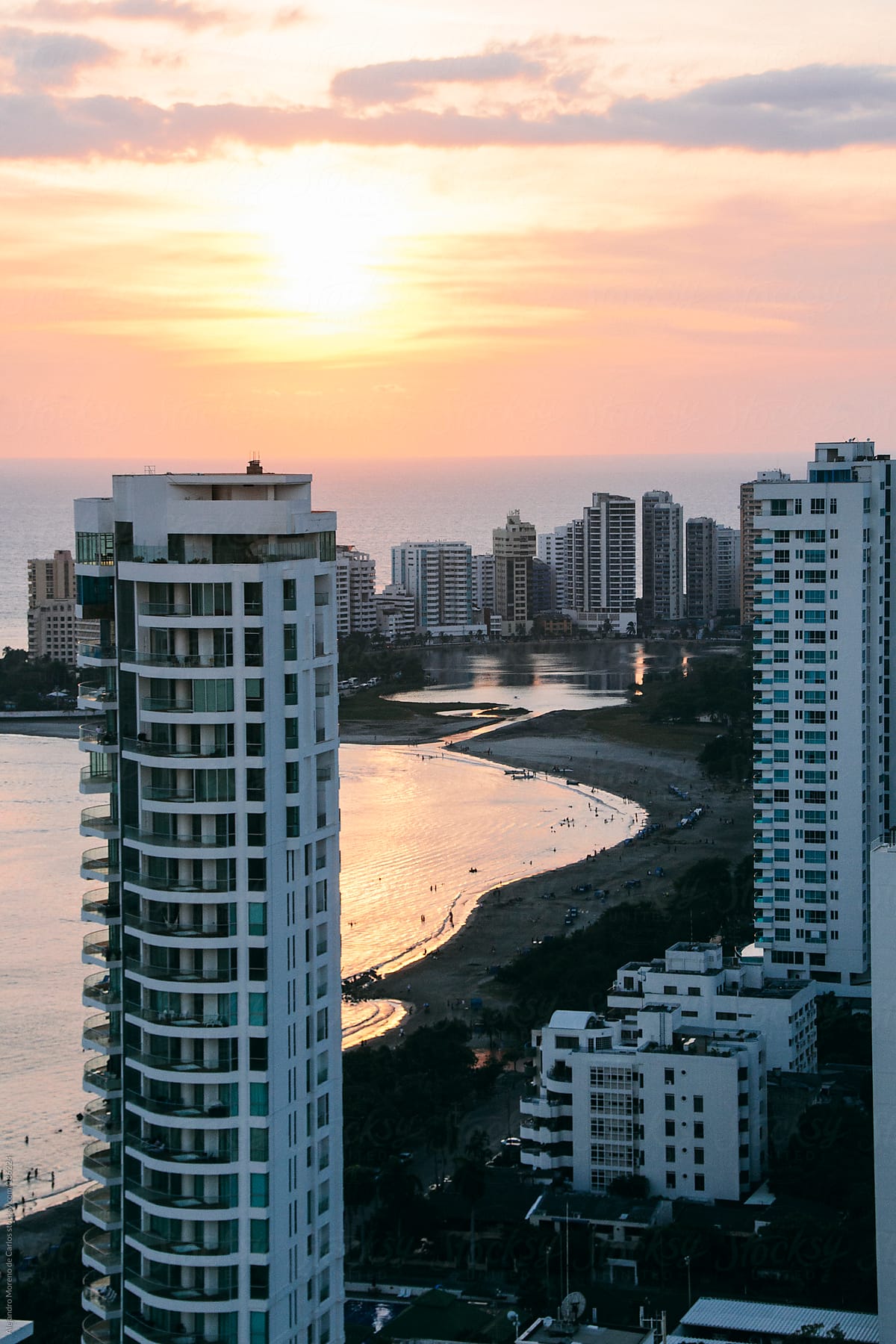 Sunset at the beach with white apartments - buildings on the foreground. Cartagena de Indias, Colombia