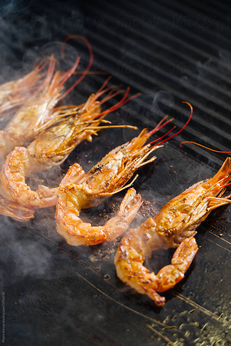 Shrimp Being Cooked on a Grill With Smoke