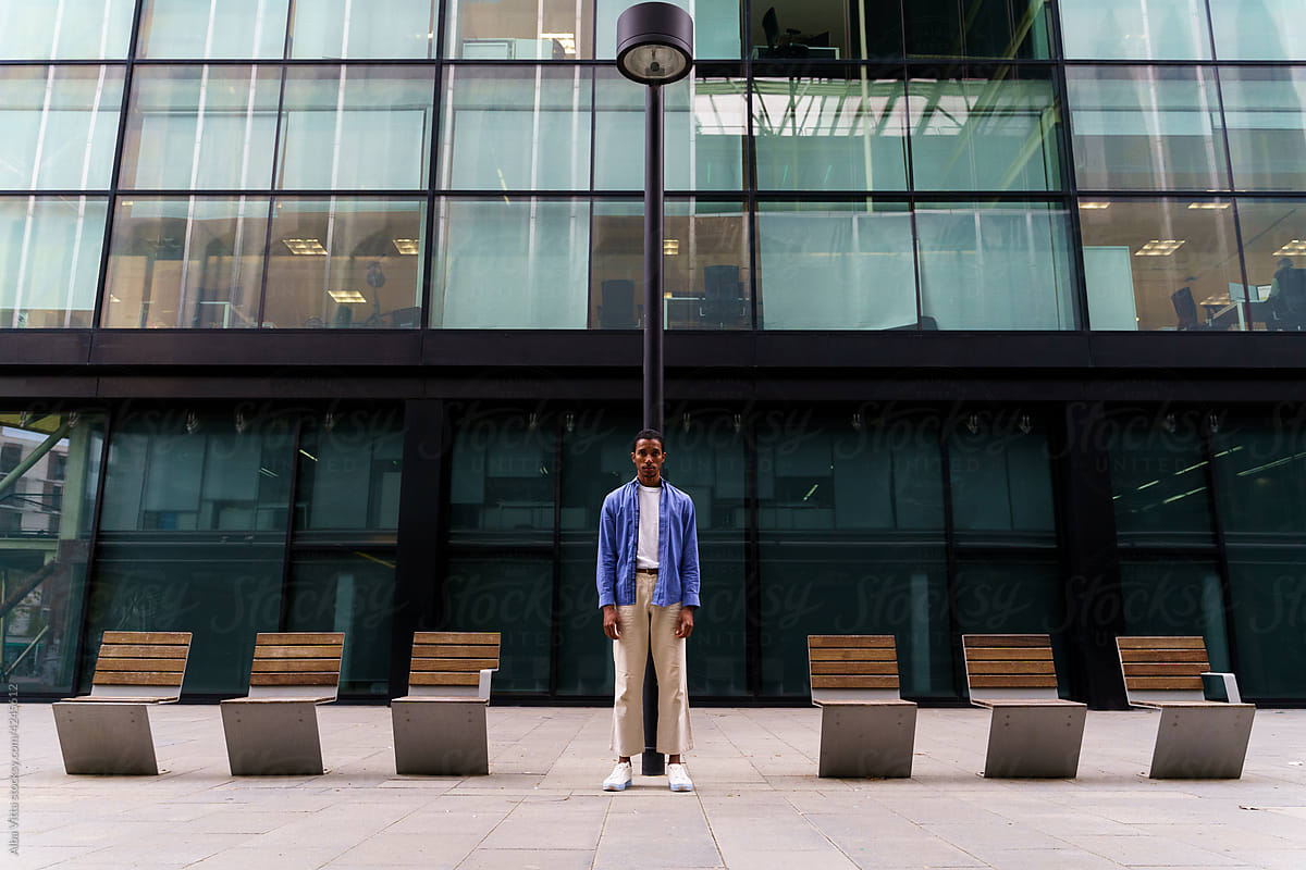 Stylish man standing in front of office building